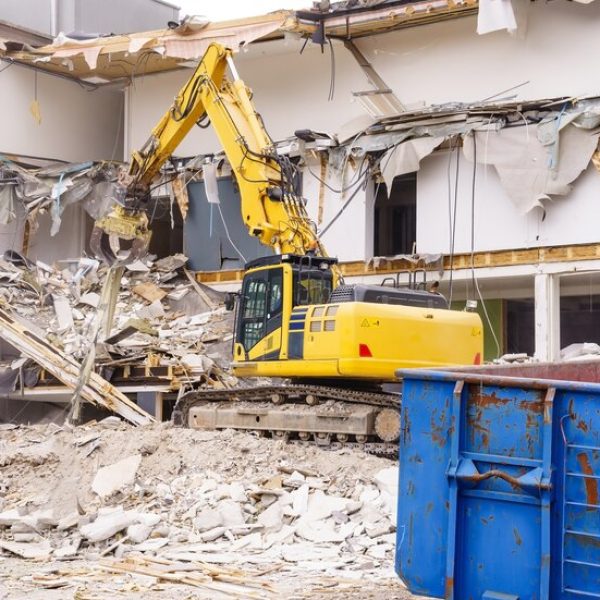 hydraulic-excavator-working-demolition-old-industrial-building_29285-264
